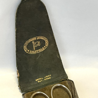 Antique double scissor set in a leather case